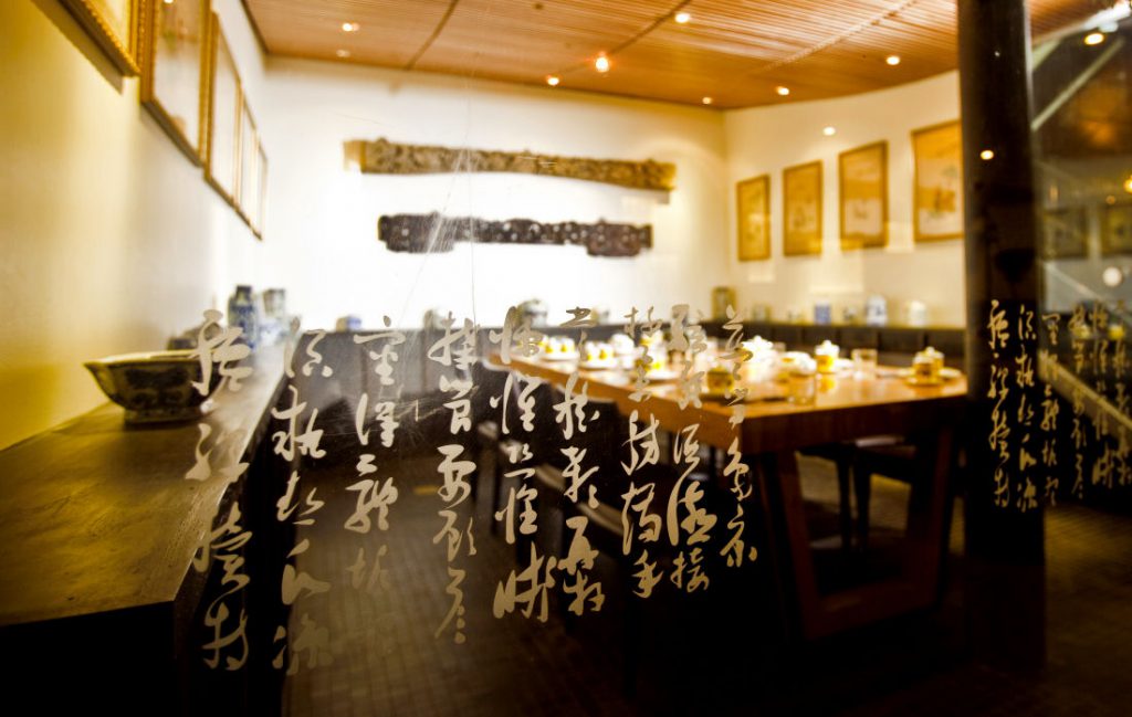 a restaurant with asian writing on the walls.
