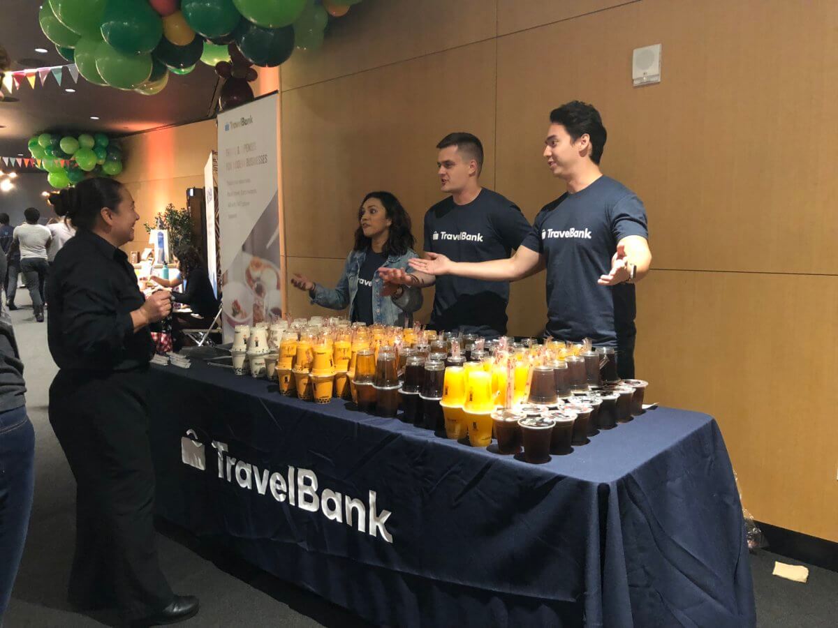 TravelBank team handing out boba tea to travel managers
