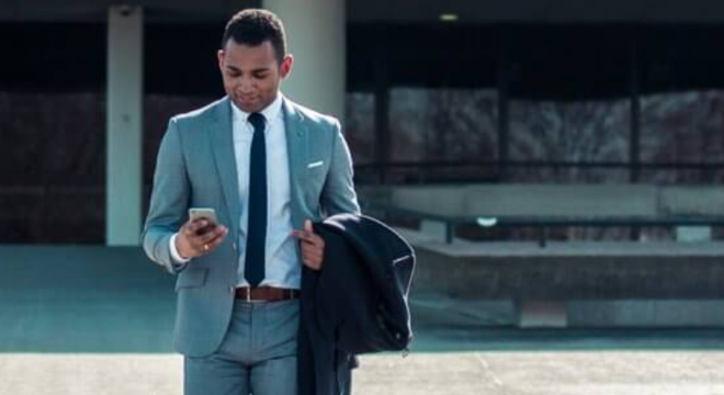 man walking on cell phone in suit