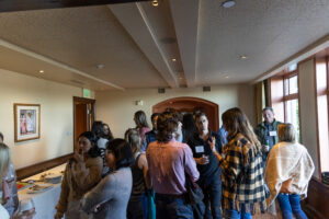 A group of people standing around in a room.