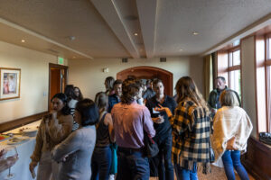 A group of people standing around in a room.