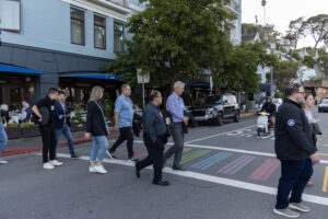 A group of people crossing a street.