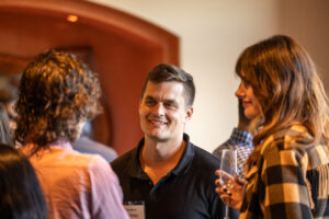 A group of people talking to each other at an event.