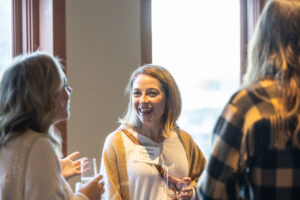 A group of women talking to each other at a networking event.