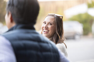 A woman is talking to a man on the street.