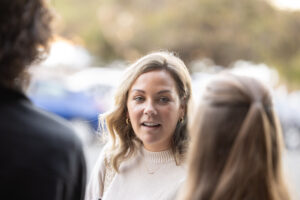 A woman is talking to another woman in the street.