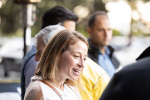 A woman is smiling at a crowd of people.