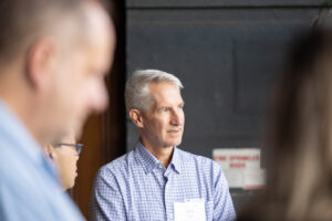 A man is talking to a group of people.