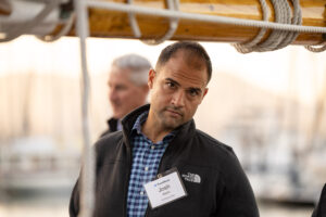 Two men standing next to each other on a boat.