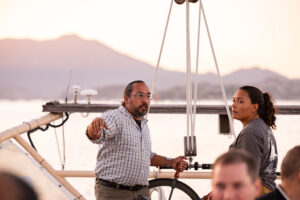 A man and woman on a boat talking to each other.