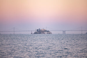 A small island in the middle of a body of water.
