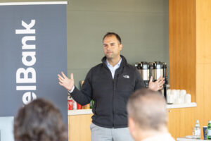 A man giving a presentation in front of a group of people.