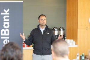 A man giving a presentation in front of a group of people.