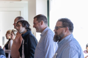 A group of people standing together in a room.