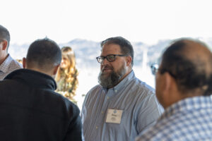 A group of people talking to each other at an event.