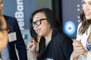 A group of people talking to each other at an event.