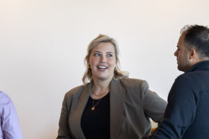 Three people in a room talking to each other.