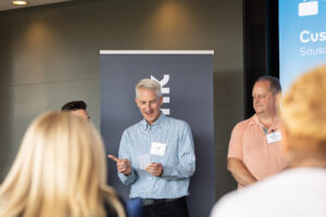 A man is giving a presentation to a group of people.