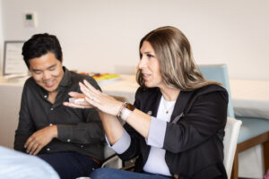 A group of people sitting around a table talking.