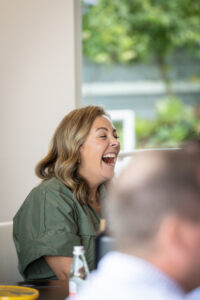 A group of people laughing at a meeting.