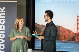 A man and woman standing in front of a projection screen.