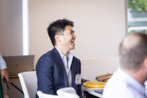 A group of people laughing at a meeting.