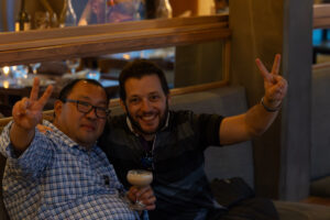 Two men sitting on a couch.