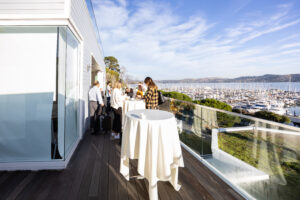 A group of people standing on a balcony.