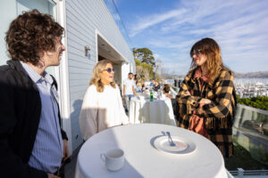 A group of people standing around a table.