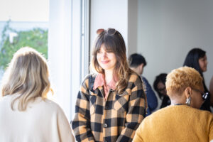 A group of women standing in front of a window.