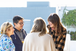 A group of people talking to each other on a rooftop.