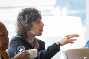 A group of people sitting around a table.