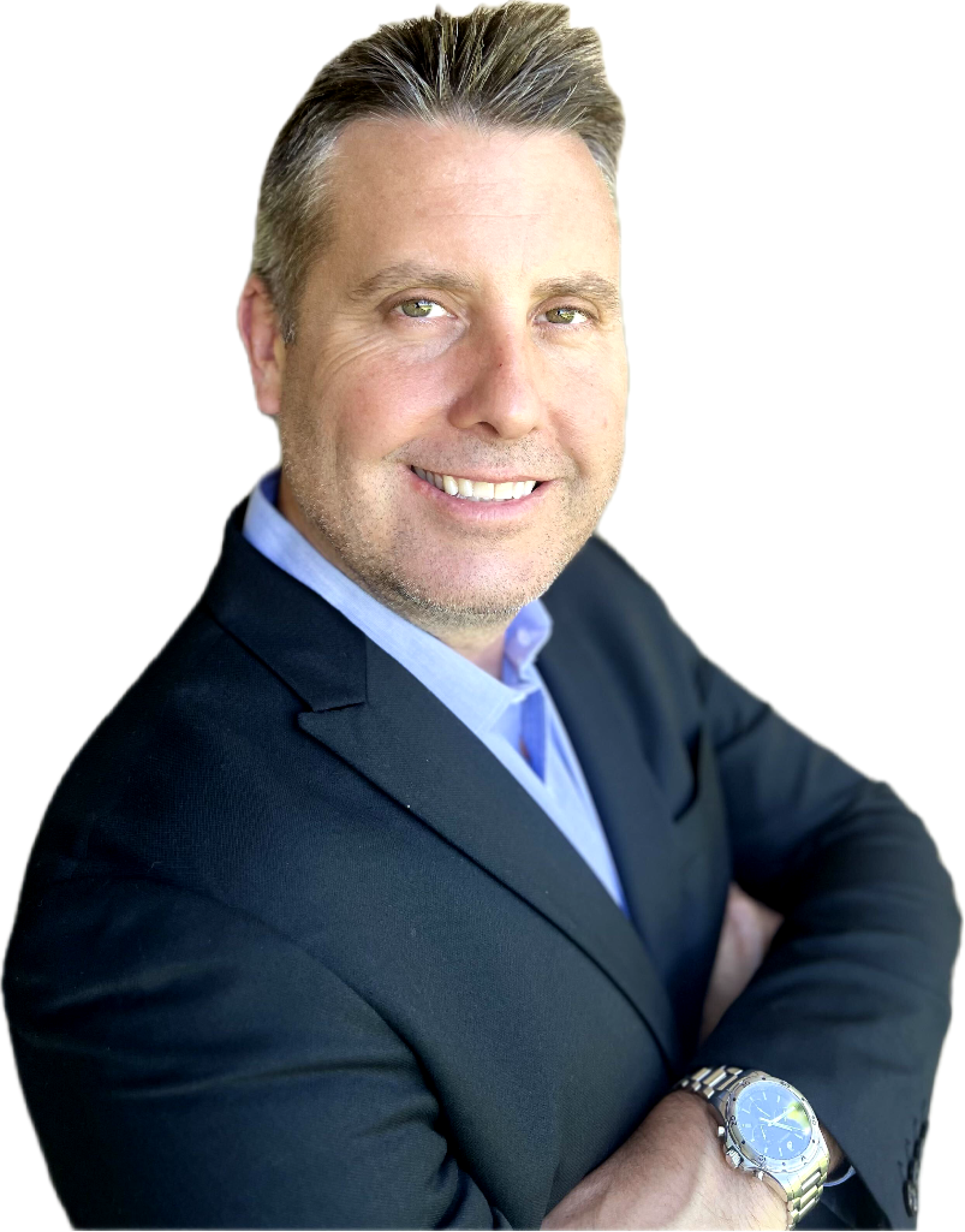 A smiling man with short hair, wearing a dark blazer and a light blue shirt, stands with his arms crossed. He is also wearing a watch on his left wrist. The background has been removed.